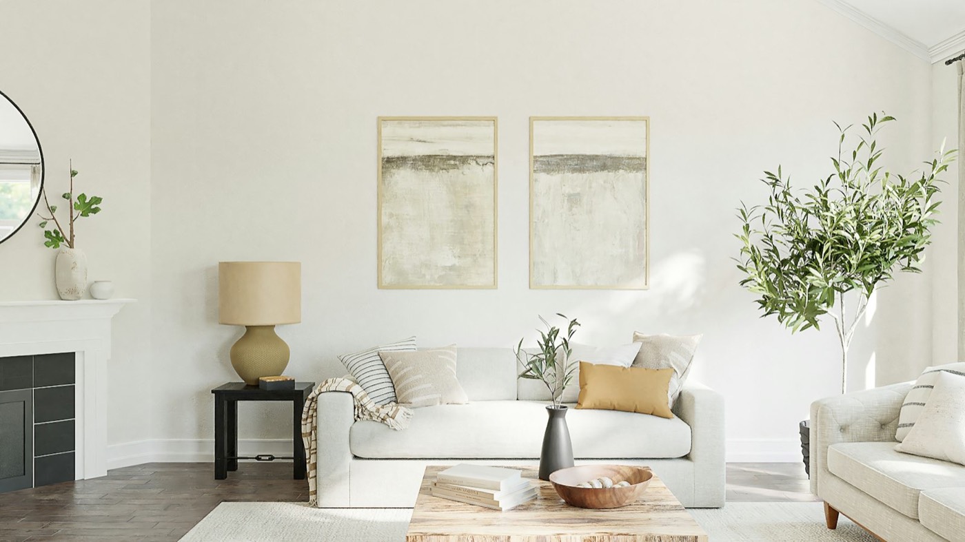 A bright living room with a pale sofa, wood floor and wide windows