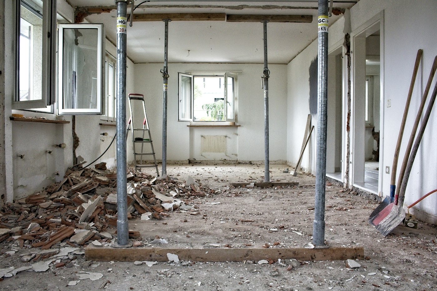 A room stripped back during renovation, with props supporting the ceiling